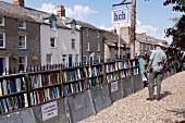 Man at cinema bookshop at village of Hay-on-Wye, Powys, Wales, UK