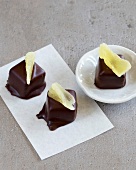 Chocolate pralines on plate and baking paper