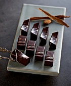 Pieces of pralines amaretto and bay leaves chocolates on plate