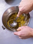 Passion fruit's juice being draining in bowl