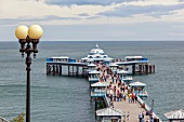 People at Victorian pier at Colwyn Bay, Wales, UK
