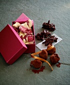 Assortment of chocolates in box and next to box