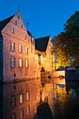 View of Hulsede Water Castle near canal, Hanover, Germany