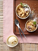 Bowl of apple and cranberry crumble with pine nut streusel, overhead view