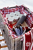 Filled picnic basket with cushions of red plaid cloth
