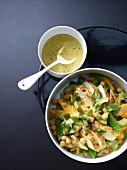 Bowl of chicken and avocado salad with mango, overhead view