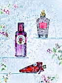 Perfume bottles in shades of pink and red on glass shelf