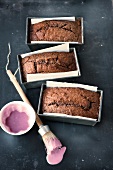 Red wine cake in baking pan with food brush and cream