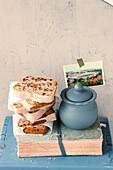 Stack of sliced spice cake with clay pot on book