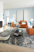 Living room with leather sofa, coffee table and rug