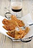Pieces of carp fish in beer batter on baking paper