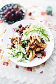 Warm savoy cabbage salad with chicken strips, cucumber and grapes
