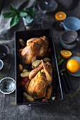 Braised guinea fowls with vegetables and oranges
