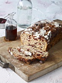 Sliced loaf of Canadian cranberry bread on wooden board