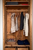 Winter cloths in wooden wardrobe