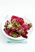 Radicchio with chicken liver and peas on plate