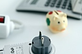 Calculator, multiple plugs, piggy bank and plug