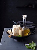 Parmesan cheese and olive oil bottle in serving bowl