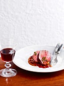 Slices of deer steaks with cranberries on plate, Bavaria, Germany