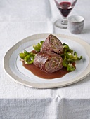 Beef roulade with roasted Brussels and sprouts leaves on plate