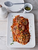 Osso buco with wild garlic and gremolata in serving dish