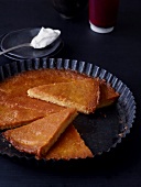 Pieces of almond cake with mandarin syrup in baking tray