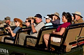 Tourist sightseeing in safari vehicle, Phinda Game Reserve, KwaZulu-Natal, South Africa
