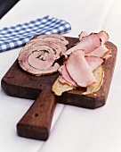 Herb roasted pork and smoked pork on wooden board