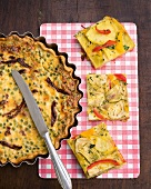 Vegetable tortilla with peas and tomato quiche on tray