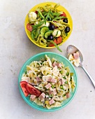 Green pasta salad and classic pasta salad in bowls