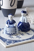 Salt and pepper shakers in the form of man and woman on coaster