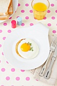 Fried egg with cress on plate