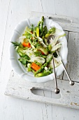 Warm vegetable salad with fork and spoon on plate