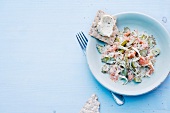 Salad with salmon, crisp bread and cream cheese on plate