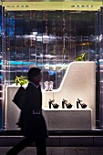 Woman walking in front of shoe shop with display cabinet, Dusseldorf, Germany