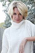 Portrait of beautiful blonde woman with short hair wearing turtleneck sweater 