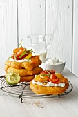 Stack of langos with chive quark on wire stand