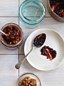 Elderberry with damson jam on plate and plum jam in jar