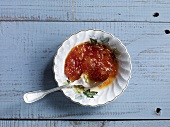 Clementines and grape marmalade with spoon in bowl