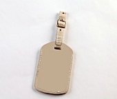 Close-up of beige leather key chain on white background