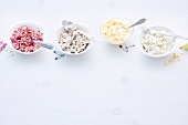 Fruits, cereal and yogurt in bowls on white background