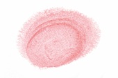 Close-up of lipstick smudged on white background 