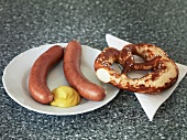 Horsemeat sausages on plate with pretzel