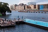 People enjoying at bathing ship pool on Spree river at Wrangelkiez, Berlin, Germany