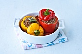 Yellow and red bell peppers stuffed with ground beef in bowl