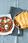 Meat pizza and shepherd's pie on plate and in baking tray