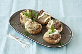 Mushrooms stuffed with ground beef in serving dish