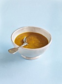 Mango curry ketchup with spoon in bowl