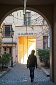 Rear of woman walking on Oranienburger streets, Berlin, Germany