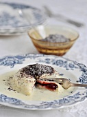 Yeast dumplings with vanilla sauce and poppy sugar on plate